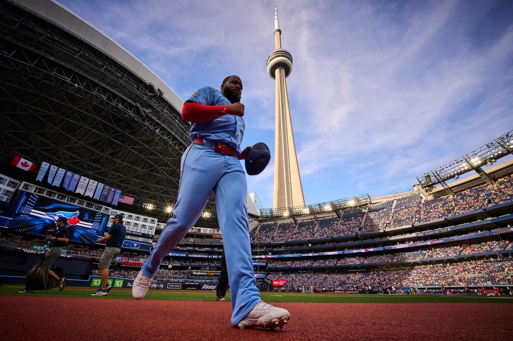 The CN Tower rises behind Toronto Blue Jays' Vladimir Guerrero Jr. as he runs before a baseball game against the Philadelphia Phillies in Toronto, Monday, June 8, 2026. (Sammy Kogan/The Canadian Press via AP)
