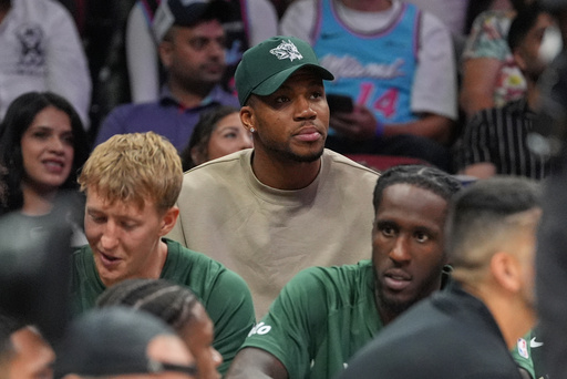 Milwaukee Bucks forward Giannis Antetokounmpo, who is recovering from COVID-19, sits behind his team's bench as he watches the second half of a preseason NBA basketball game against the Miami Heat, Monday, Oct. 6, 2025, in Miami. (AP Photo/Rebecca Blackwell) Milwaukee Bucks forward Giannis Antetokounmpo, who is recovering from COVID-19, sits behind his team's bench as he watches the second half of a preseason NBA basketball game against the Miami Heat, Monday, Oct. 6, 2025, in Miami. (AP Photo/Rebecca Blackwell)