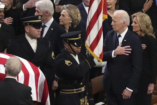 President Joe Biden and first lady Jill Biden watch as a joint services body bearer team carries the casket of former President Jimmy Carter during the state funeral at Washington National Cathedral in Washington, Thursday, Jan. 9, 2025. (AP Photo/Jacquelyn Martin) President Joe Biden and first lady Jill Biden watch as a joint services body bearer team carries the casket of former President Jimmy Carter during the state funeral at Washington National Cathedral in Washington, Thursday, Jan. 9, 2025. (AP Photo/Jacquelyn Martin)