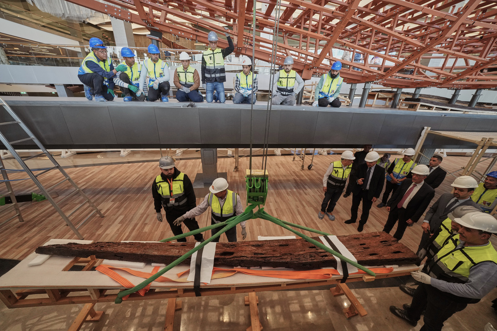 Archeologists prepare to reassemble the second solar boat of King Khufu, at the Grand Egyptian Museum in Giza, Egypt, Tuesday, Dec. 23, 2025. (AP Photo/Amr Nabil)