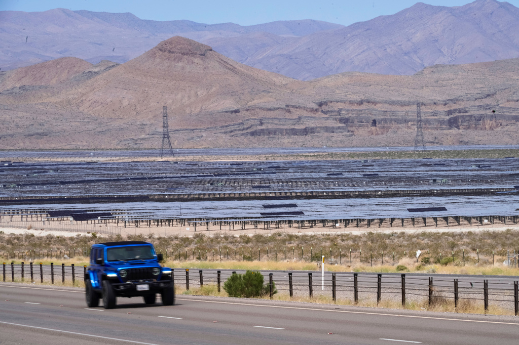 Solar panels stretch out across the desert floor, Thursday, April 2, 2026, in North Las Vegas. (AP Photo/Ty ONeil)