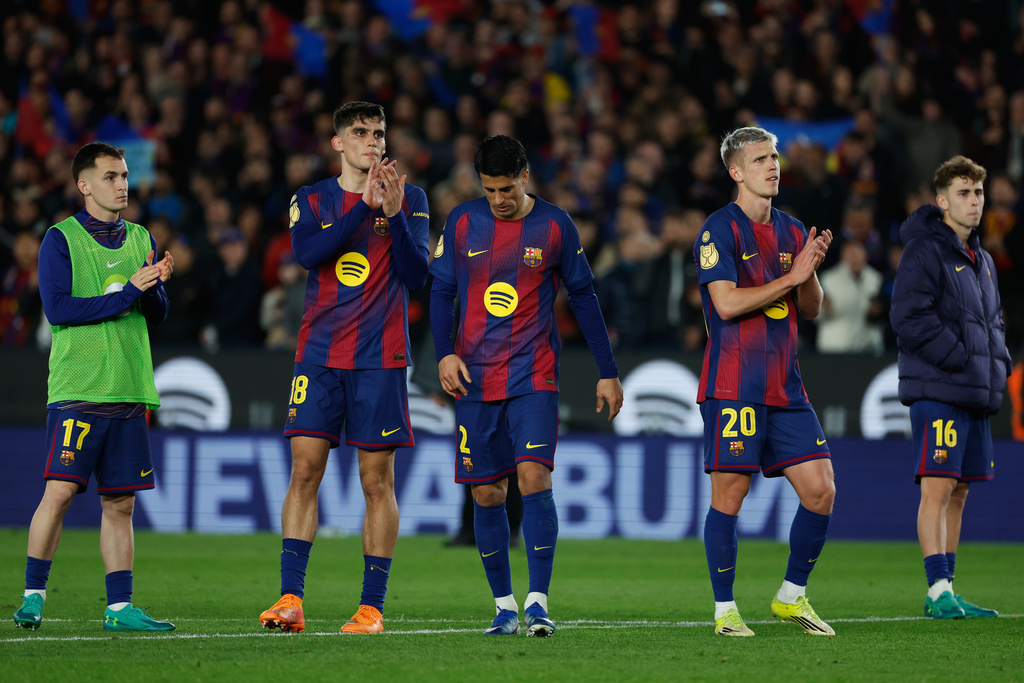 Barcelona's Marc Casado, from left, Gerard Martin, Joao Cancelo, Dani Olmo and Fermin Lopez react after the Copa del Rey semifinal second leg soccer match between Barcelona and Atletico Madrid in Barcelona, Spain, Tuesday, March 3, 2026. (AP Photo/Joan Monfort)