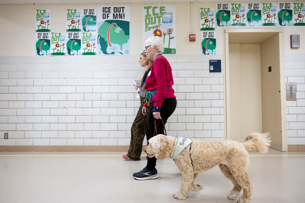 School social worker Nicole Herje walks through the hallway at Valley View Elementary School with Linda Buchs-Hammonds and her therapy dog Sage at Valley View Elementary School on April 29, 2026, in Columbia Heights, Minn. (Ellen Schmidt/MinnPost via AP)
