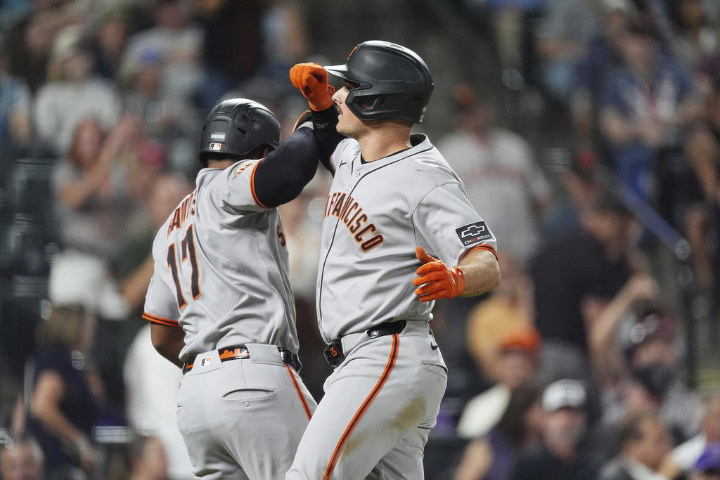 San Francisco Giants' Heliot Ramos, left, congratulates Matt Chapman as he crosses home plate after hitting a three-run home run off Colorado Rockies relief pitcher Juan Mejia in the sixth inning of a baseball game Wednesday, Sept. 3, 2025, in Denver. (AP Photo/David Zalubowski)