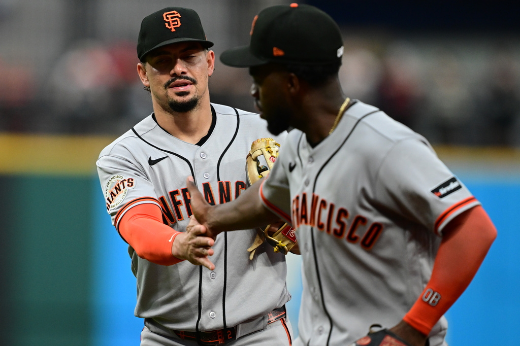 San Francisco Giants shortstop Willy Adames is congratulated by second baseman Osleivis Basabe after turning double play during the sixth inning of a baseball game against the Cleveland Guardians, Wednesday, Aug. 19, 2026, in Cleveland. (AP Photo/David Dermer)