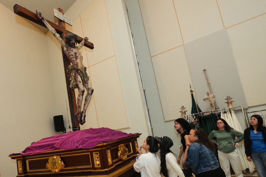 Corpus Christi Catholic Church youth members look up at a statue of Jesus crucified during a rehearsal for their Good Friday procession, Monday, March 23, 2026, in Miami, Fla. (AP Photo/Marta Lavandier)