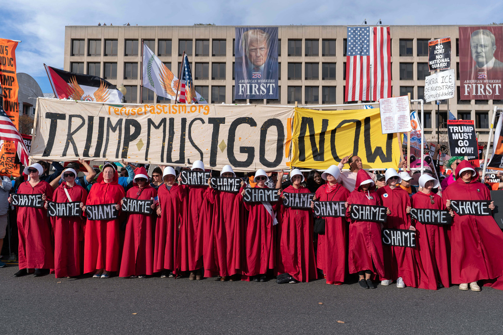 Demonstrators dressed as the TV series The Handmaid's Tale march to the U.S. Supreme Court during a Trump Must Go Now rally in Washington, Wednesday, Nov. 5, 2025. (AP Photo/Jose Luis Magana)