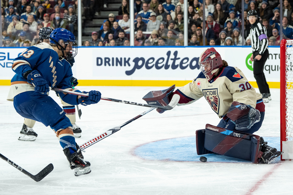 Montreal Victoire goaltender Sandra Abstreiter (30) stops Vancouver Goldeneyes' Tereza Vanišová during the third period of a PWHL hockey game in Vancouver, British Columbia, Saturday, Dec. 20, 2025. (Ethan Cairns/The Canadian Press via AP)