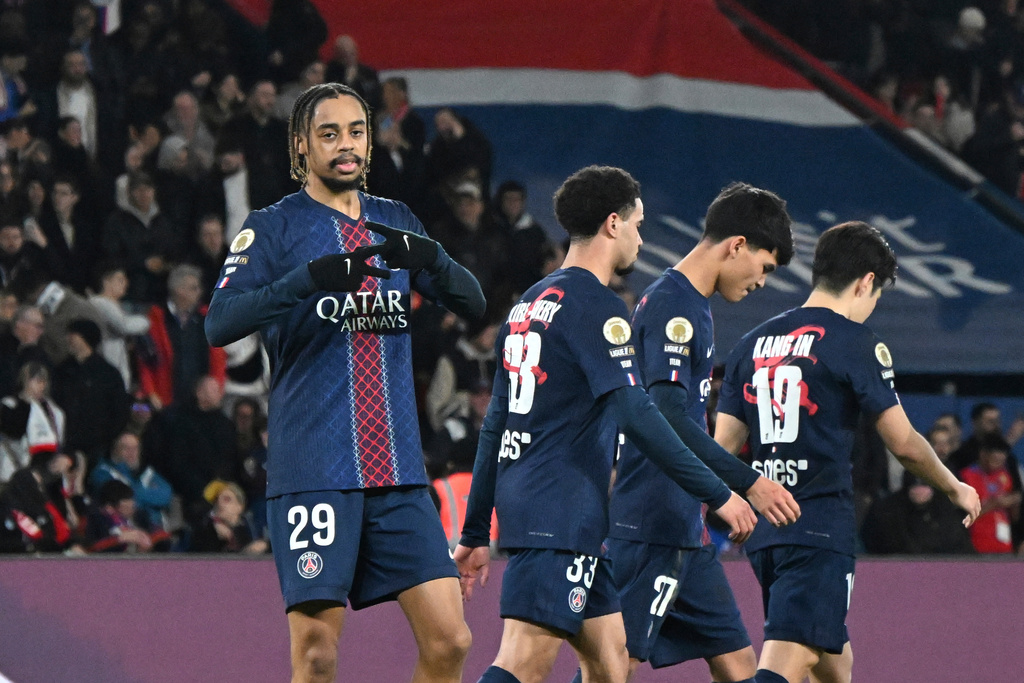 PSG's Bradley Barcola, left, celebrates after scoring his side's second goal during the French League One soccer match between Paris Saint-Germain and Metz in Paris, France, Saturday, Feb. 21, 2026. (AP Photo/Emma Da Silva)