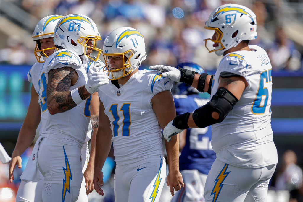 Los Angeles Chargers kicker Cameron Dicker (11) is congratulated by teammates after kicking a field goal against the New York Giants during the second quarter of an NFL football game, Sunday, Sept. 28, 2025, in East Rutherford, N.J. (AP Photo/Adam Hunger)
