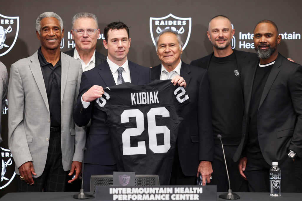 Las Vegas Raiders new head coach Klint Kubiak, third from left, poses with from left, Mike Haynes, Howie Long, Jim Plunkett, general manager John Spytek and Charles Woodson during an introductory news conference at the NFL football team's training facility Tuesday, Feb. 10, 2026, in Henderson, Nev. (AP Photo/Ian Maule)