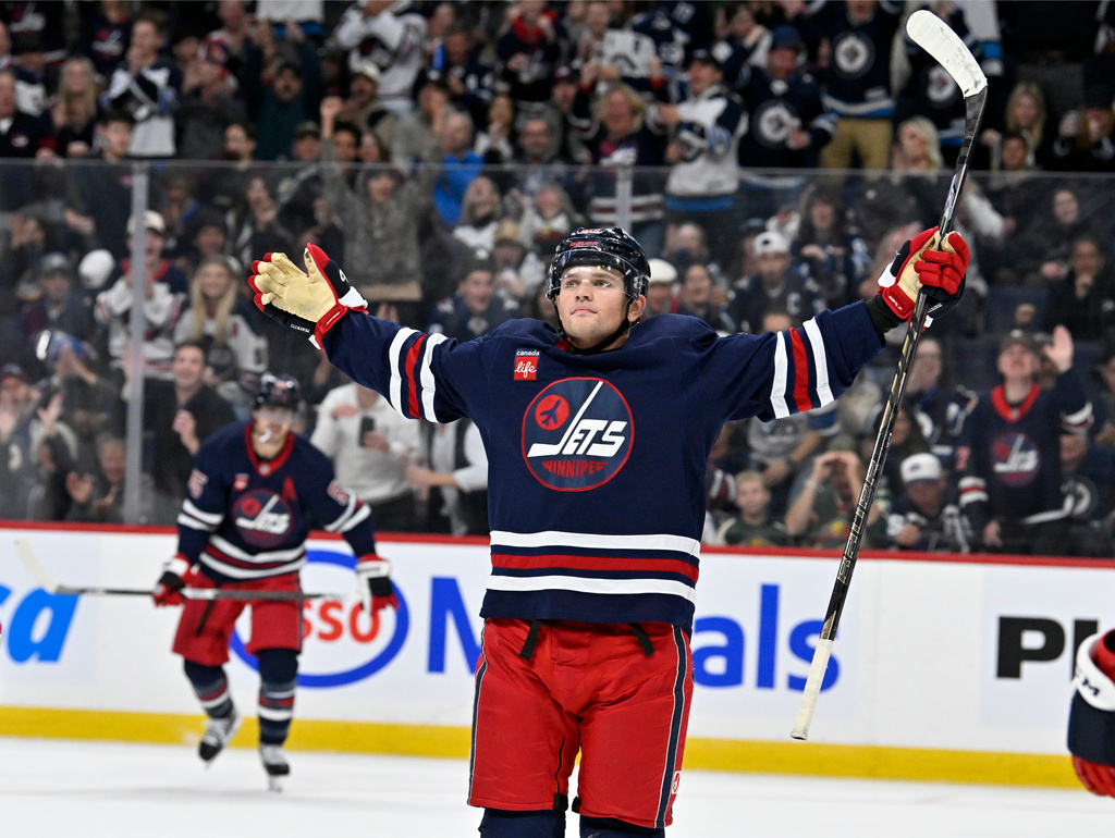 Winnipeg Jets' Cole Perfetti (91) celebrates his goal against the Minnesota Wild during second period NHL hockey action in Winnipeg, Manitoba, Tuesday, Oct. 13, 2026. (Fred Greenslade/The Canadian Press via AP)