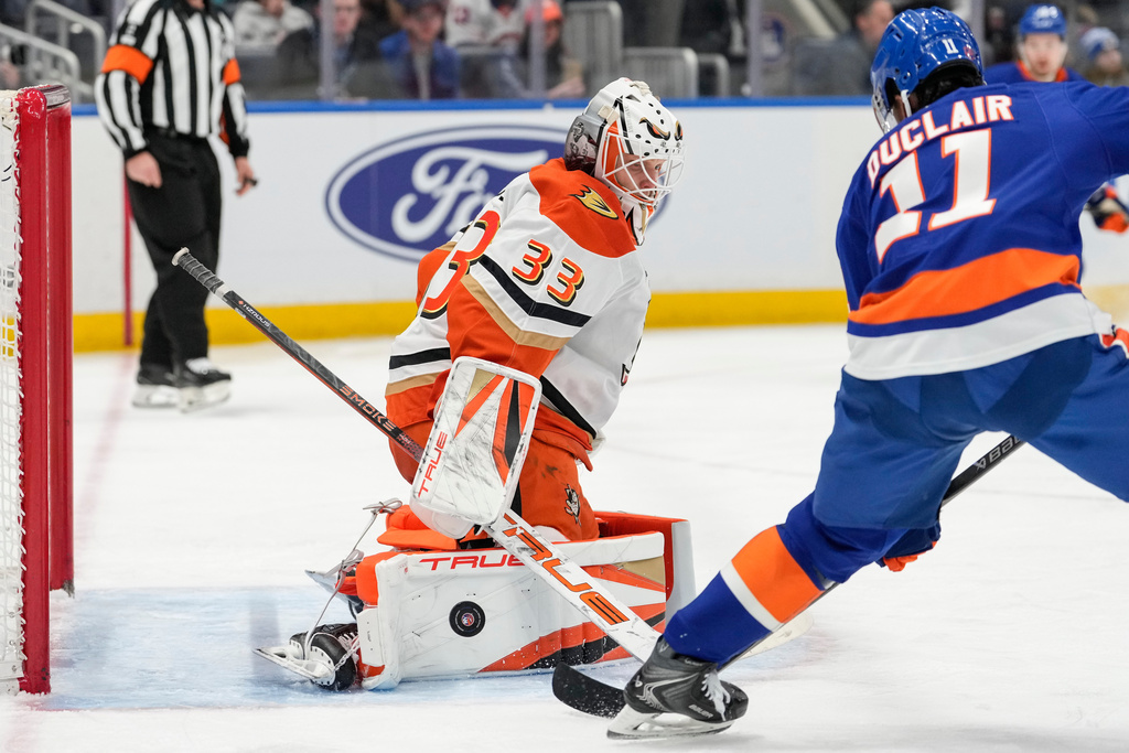 Anaheim Ducks goaltender Ville Husso (33) protect the net from New York Islanders left wing Anthony Duclair (11) during the second period of an NHL hockey game, Thursday, Dec. 11, 2025, in Elmont, N.Y. (AP Photo/Yuki Iwamura)