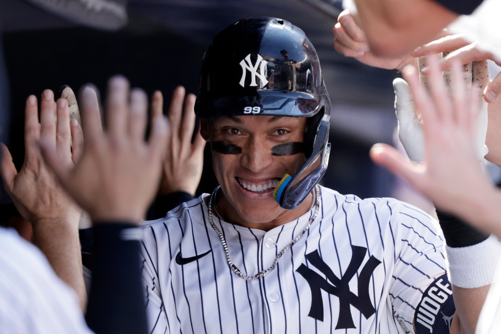 FILE - New York Yankees' Aaron Judge is congratulated after hitting a two-run home run during the seventh inning of a baseball game against the Athletics, June 29, 2025, in New York. (AP Photo/Adam Hunger, File)