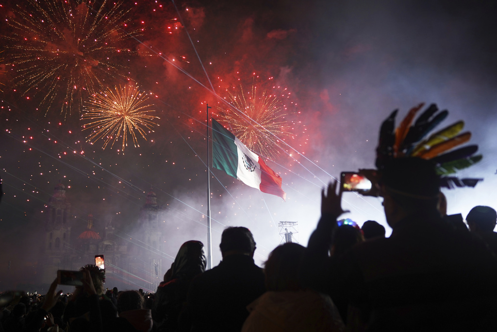 People watch fireworks during the Independence Day celebration at the Zocalo, Mexico City's main square, Monday, Sept. 15, 2025. (AP Photo/Jon Orbach)