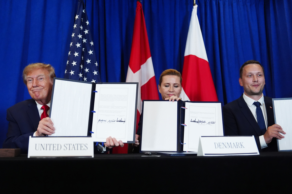 President Donald Trump signs a security agreement with Denmark's Prime Minister Mette Frederiksen and Greenland's Prime Minister Jens-Frederik Nielsen during the United Nations General Assembly, Tuesday, Sept. 22, 2026, at the UN headquarters. (AP Photo/Julia Demaree Nikhinson)