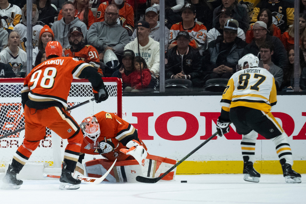 Anaheim Ducks goaltender Lukas Dostal (1) blocks the shot by Pittsburgh Penguins center Sidney Crosby (87) during the first period of an NHL hockey game, Tuesday, Oct. 14, 2025, in Anaheim, Calif. (AP Photo/Kyusung Gong)