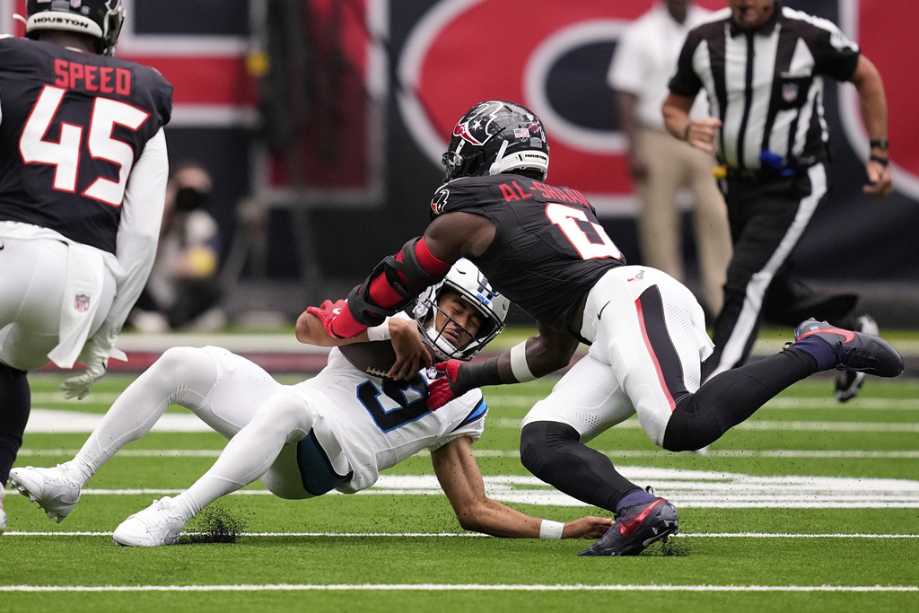 Carolina Panthers quarterback Bryce Young is tackled by Houston Texans linebacker Azeez Al-Shaair during the first half of an NFL preseason football game on Saturday, Aug. 16, 2025, in Houston. (AP Photo/David J. Phillip)