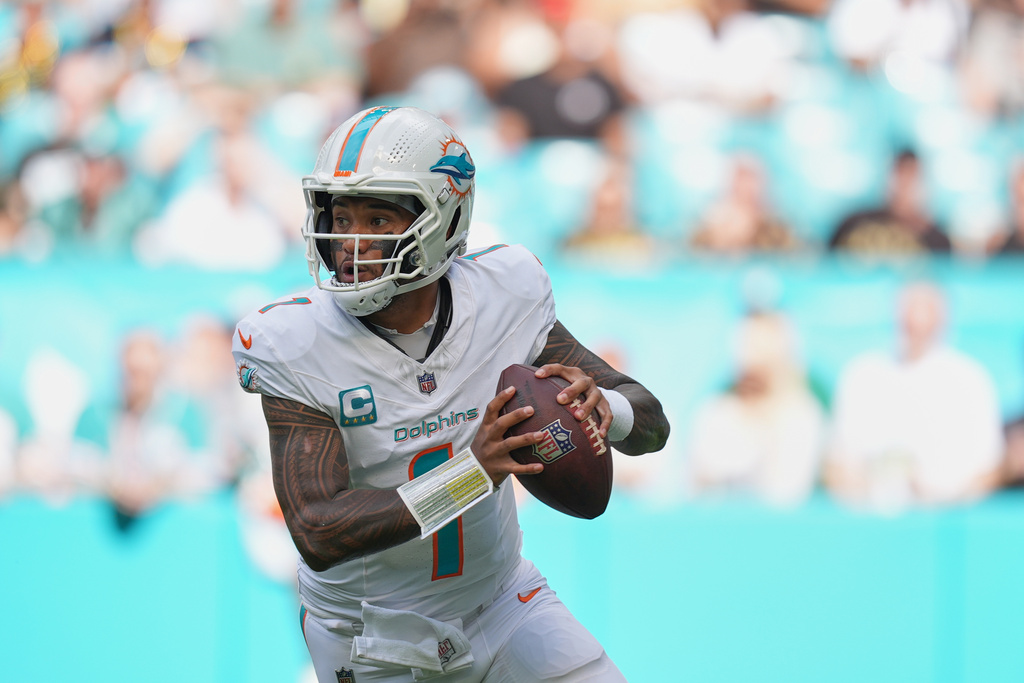 Miami Dolphins quarterback Tua Tagovailoa (1) aims a pass during the first half of an NFL football game against the New Orleans Saints Sunday, Nov. 30, 2025, in Miami Gardens, Fla. (AP Photo/Rebecca Blackwell)