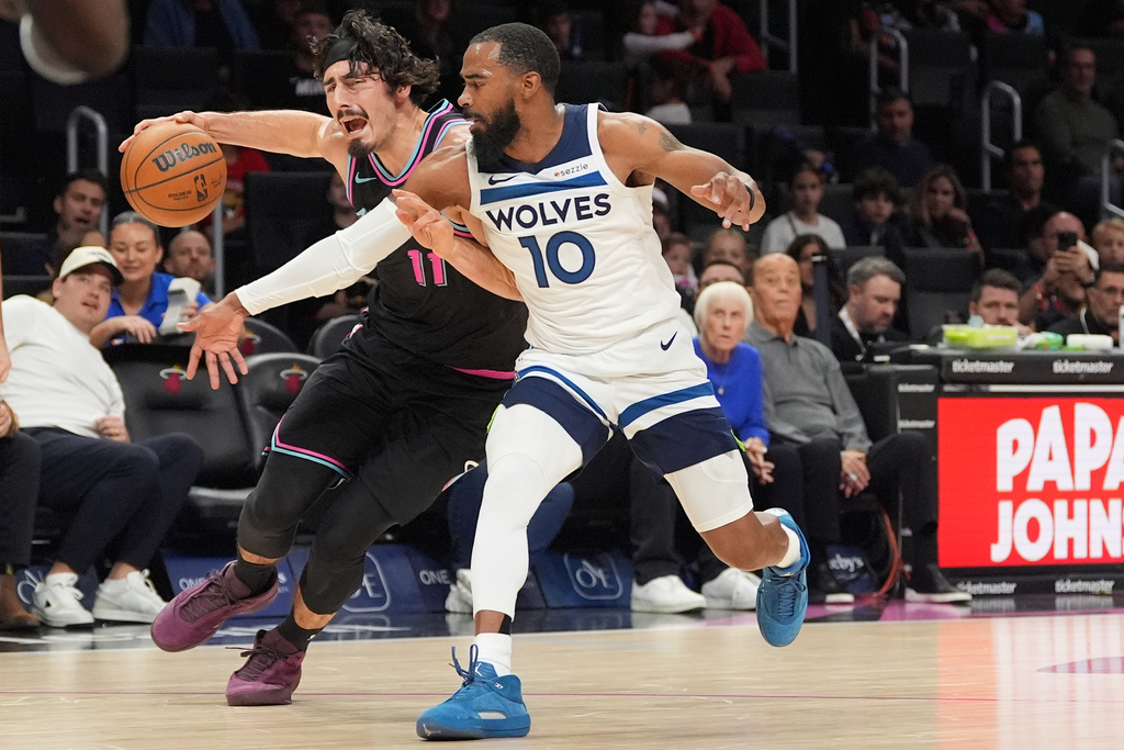 Miami Heat forward Jaime Jaquez Jr. (11) clashes with Minnesota Timberwolves guard Mike Conley (10) during the first half of an NBA basketball game, Saturday, Jan. 3, 2026, in Miami. (AP Photo/Rebecca Blackwell)