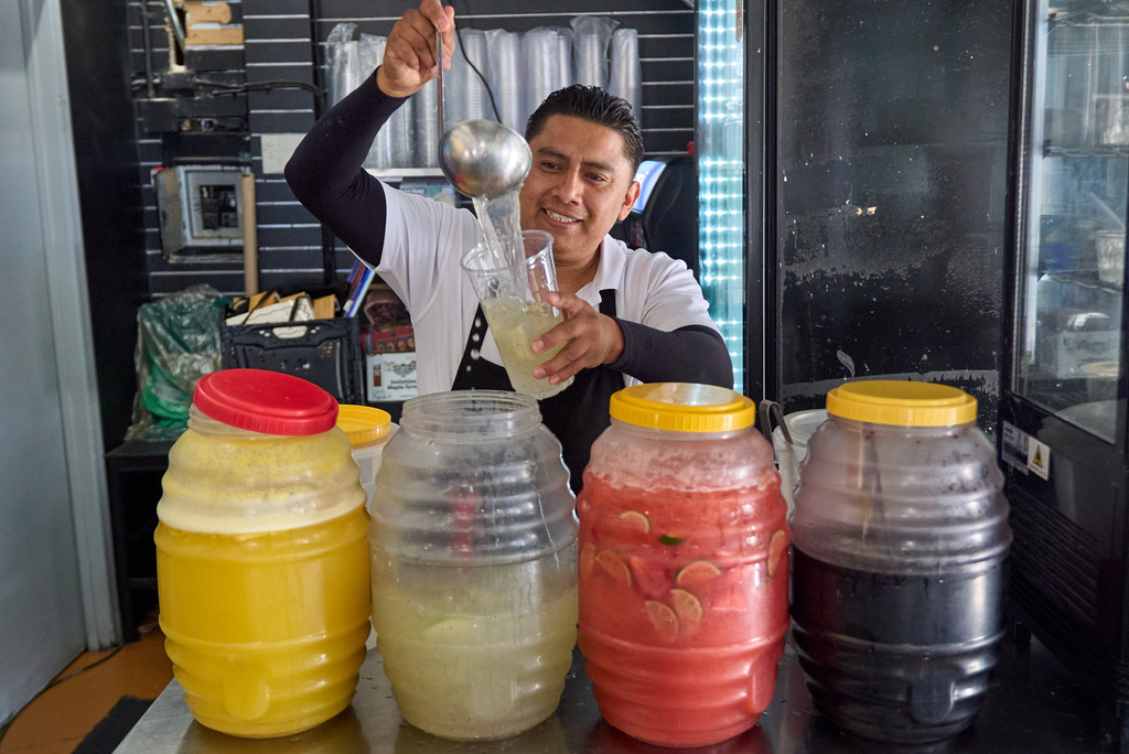 Waiter Usiel Macias serves a lemonade at Cuernavaca's Grill downtown Los Angeles, Tuesday, April 28, 2026. (AP Photo/Damian Dovarganes)