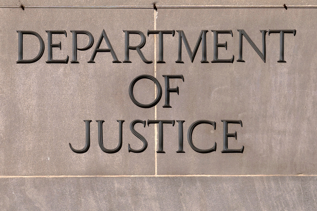 FILE - A sign of the U.S. Department of Justice is seen on the headquarters building in Washington, Nov. 18, 2024. (AP Photo/Jose Luis Magana, File)