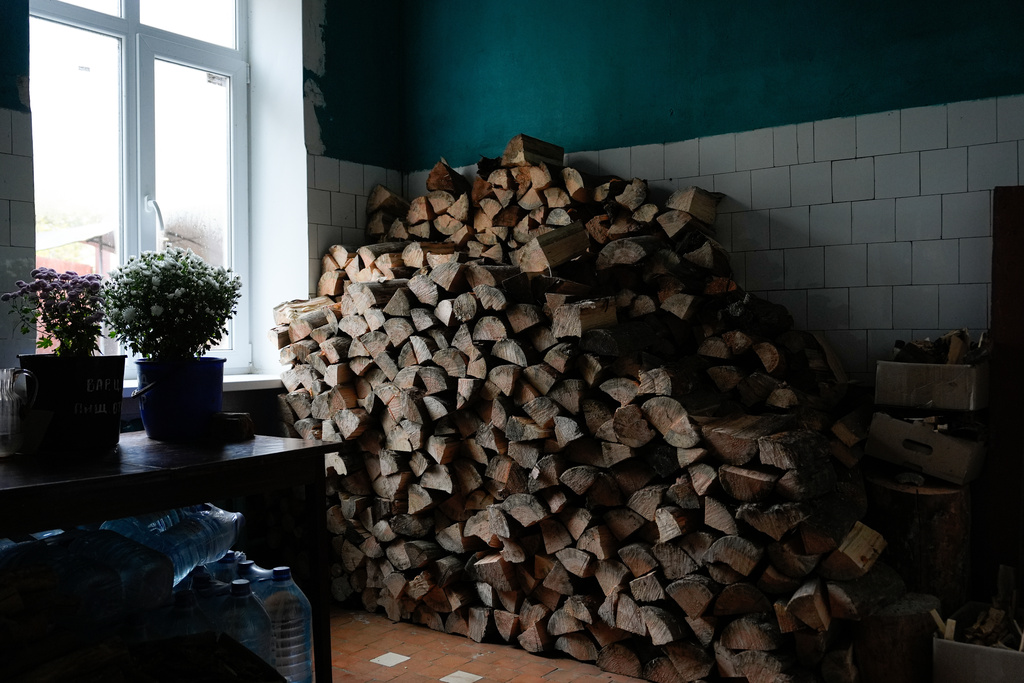 Logs are stored near the kitchen of Shostka Central District Hospital, where cooks now use a wood-burning stove to prepare meals for patients, during a rolling blackout, Thursday, Oct. 16, 2025, in Shostka, Ukraine. (AP Photo/Julia Demaree Nikhinson)