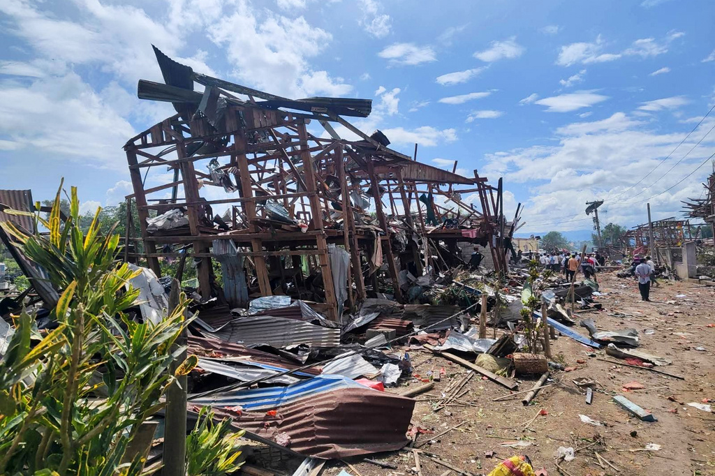 This handout photo provided by Palaung Land shows rescuers and local residents carrying out search operations in the aftermath of an explosion in Kaungtup village in Namhkam township in Shan state, Myanmar on Sunday, May 31, 2026. (Palaung Land via AP)