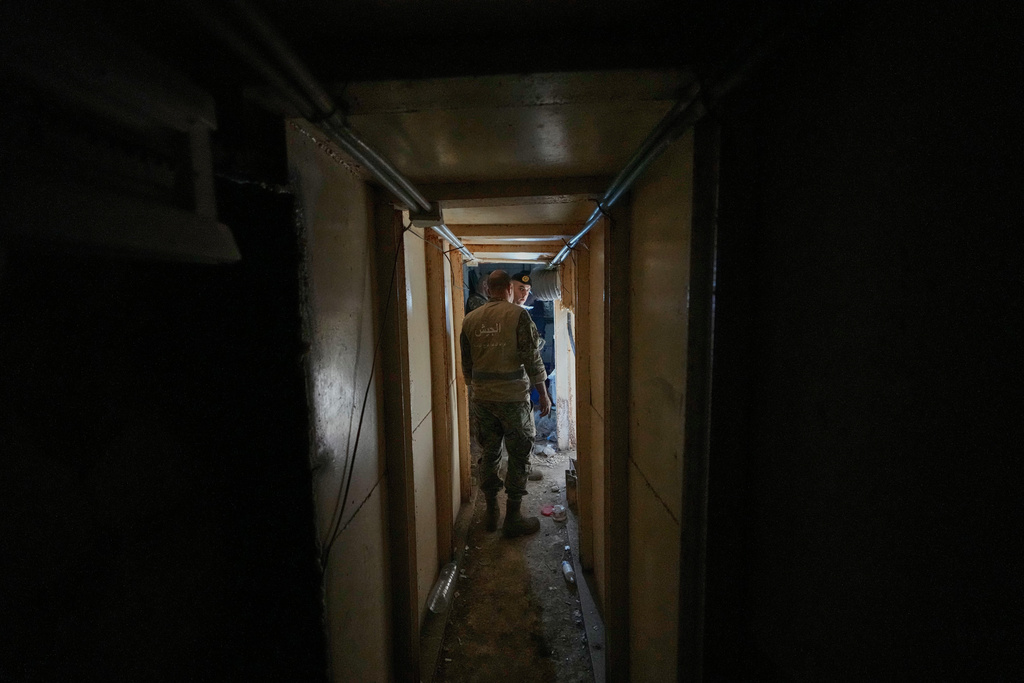 Lebanese army soldiers walk through a tunnel dug into a mountain that was used by Hezbollah militants as a clinic and storage facility, near the Lebanese-Israeli border in the Zibqin Valley, southern Lebanon, Friday, Nov. 28, 2025. (AP Photo/Bilal Hussein)