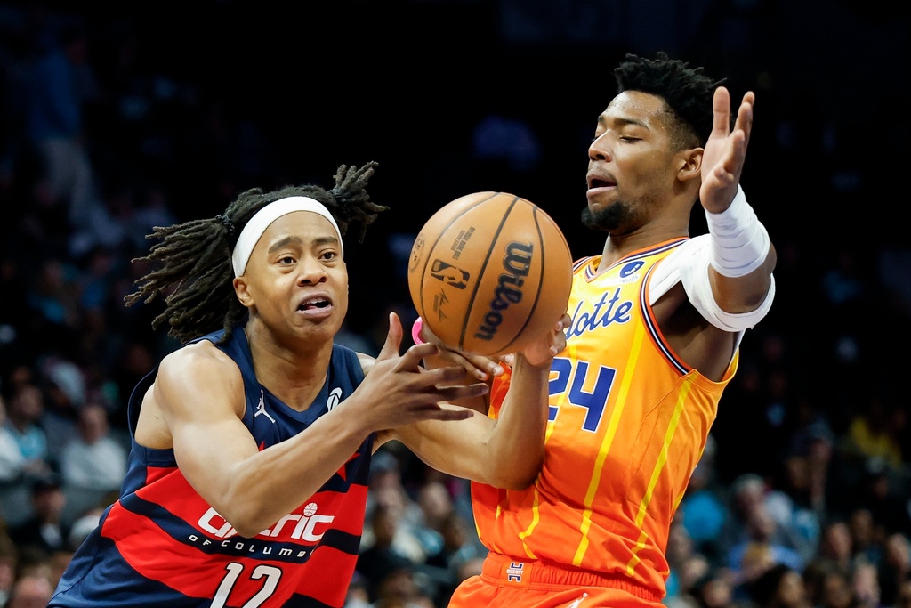 Washington Wizards guard Tre Johnson (12) drives to the basket against Charlotte Hornets forward Brandon Miller during the second half of an NBA basketball game in Charlotte, N.C., Saturday, Jan. 24, 2026. (AP Photo/Nell Redmond)