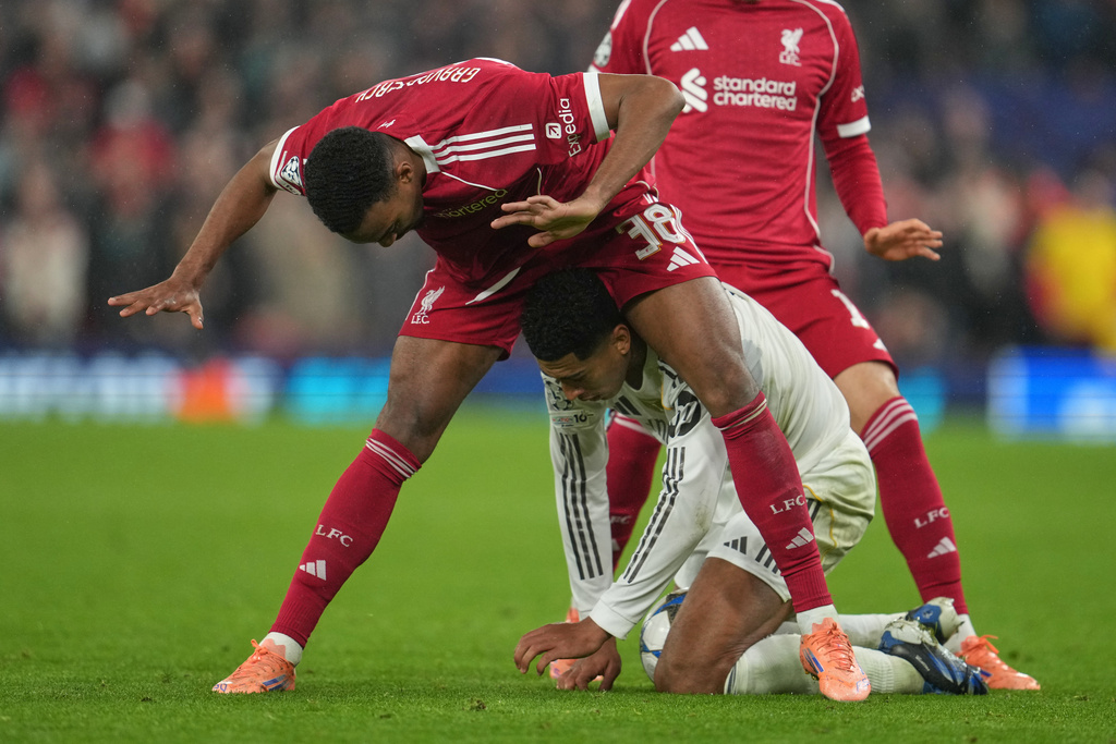 Liverpool's Ryan Gravenberch, top, and Real Madrid's Jude Bellingham fight for the ball during the Champions League soccer match between Liverpool and Real Madrid in Liverpool, England, Tuesday, Nov. 4, 2025. (AP Photo/Jon Super)