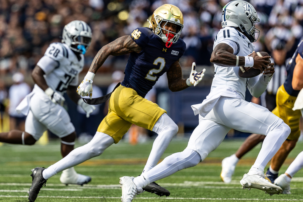 Notre Dame cornerback DJ McKinney (2) attempts to run down Rice quarterback Jacurri Brown (11) during the first half of an NCAA college football game, Saturday, Sept. 12, 2026, in South Bend, Ind. (AP Photo/Paul Barnick)