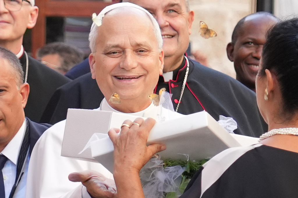 Pope Leo XIV receives a box with butterflies as he arrives at the Basilica Sanctuary of the Mother of Good Counsel in Genazzano, central Italy, Monday, Sept. 7, 2026. (AP Photo/Andrew Medichini)