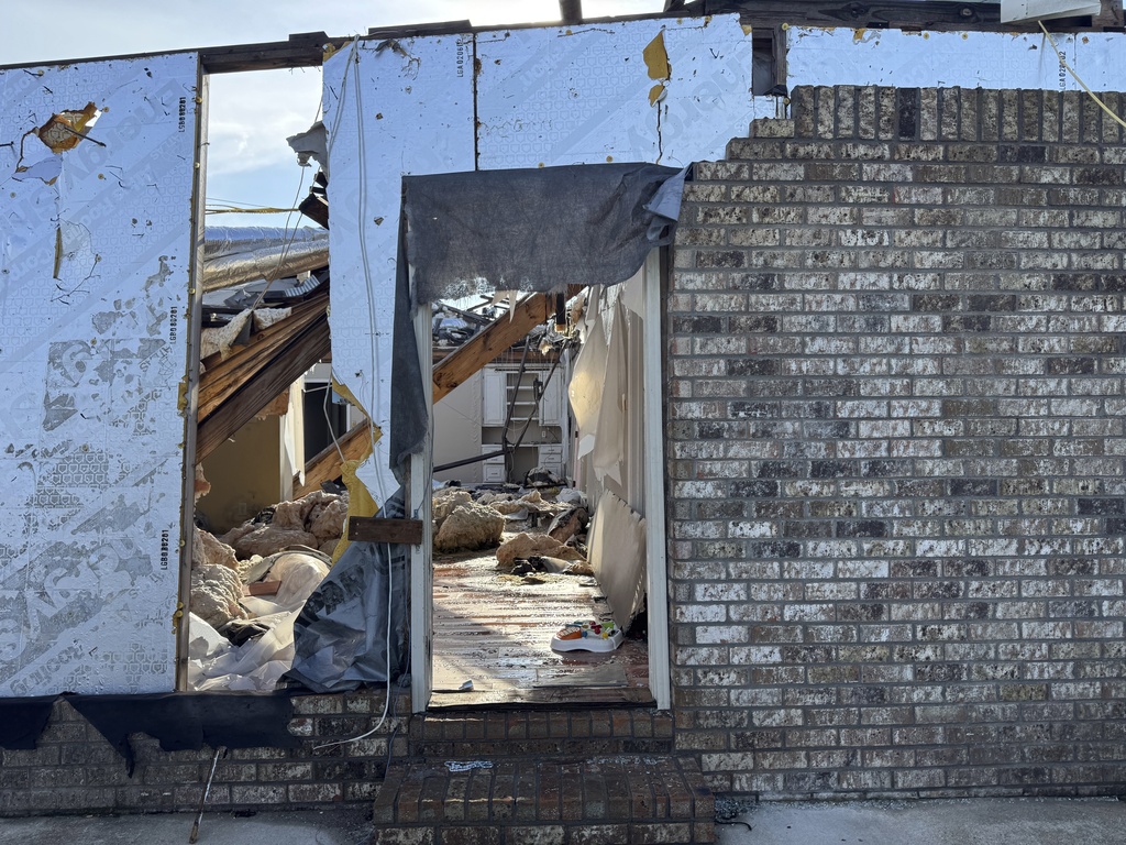 Early morning light shines through the shell of Buddy Anthony's destroyed home on Thursday, Aug. 14, 2025, in Tylertown, Miss. (AP Photo/Sophie Bates)