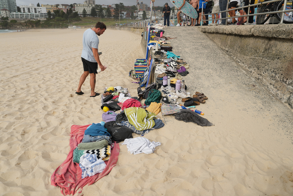 A man looks at belongings stacked up following a shooting the day prior at Sydney's Bondi Beach, Monday, Dec. 15, 2025. (AP Photo/Mark Baker)