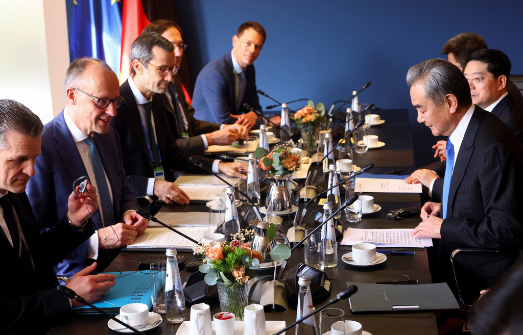 German Chancellor Friedrich Merz, second from left, attends a meeting with Chinese Foreign Minister Wang Yi, right, during the Munich Security Conference (MSC) in Munich, Germany, Saturday Feb. 14, 2026. (Thilo Schmuelgen/Pool Photo via AP)