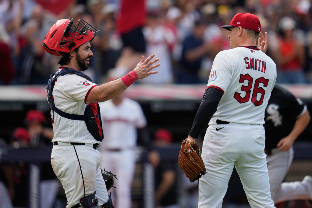 Cleveland Guardians catcher Austin Hedges, left, and pitcher Cade Smith (36) celebrate after the Guardians defeated the Chicago White Sox in a baseball game in Cleveland, Wednesday, Sept. 16, 2026. (AP Photo/Sue Ogrocki)