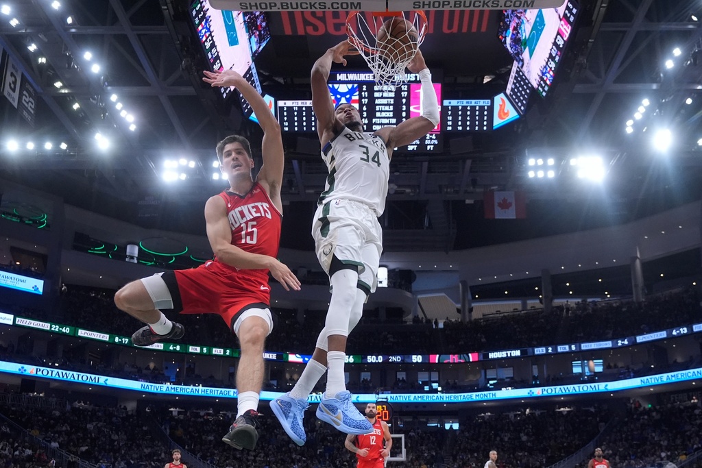 Milwaukee Bucks' Giannis Antetokounmpo dunks past Houston Rockets' Reed Sheppard during the first half of an NBA basketball game Sunday, Nov. 9, 2025, in Milwaukee. (AP Photo/Morry Gash)