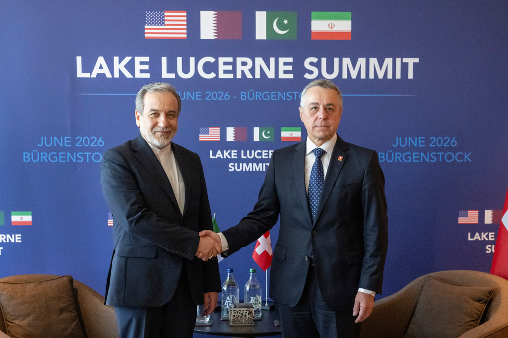 Iran’s Foreign Minister Abbas Araghchi, left, and Switzerland's Foreign Minister Federal councillor Ignazio Cassis, right, shake hands at bilateral discussions at the Buergenstock resort in Obbuergen, near Lucerne, Switzerland, Sunday, June 21, 2026. (Urs Flueeler/Keystone via AP)