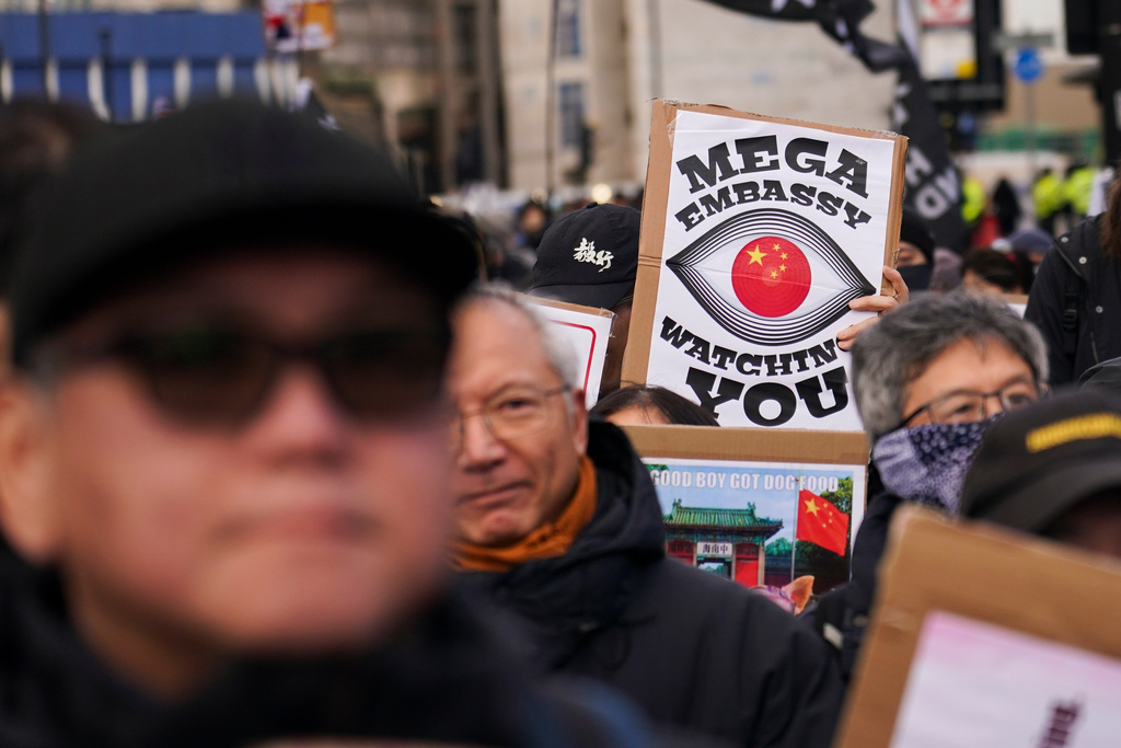 Demonstrators hold placards and flags as they attend a protest against the proposed Chinese embassy, in London, Saturday, Jan. 17, 2026. (AP Photo/Alberto Pezzali)