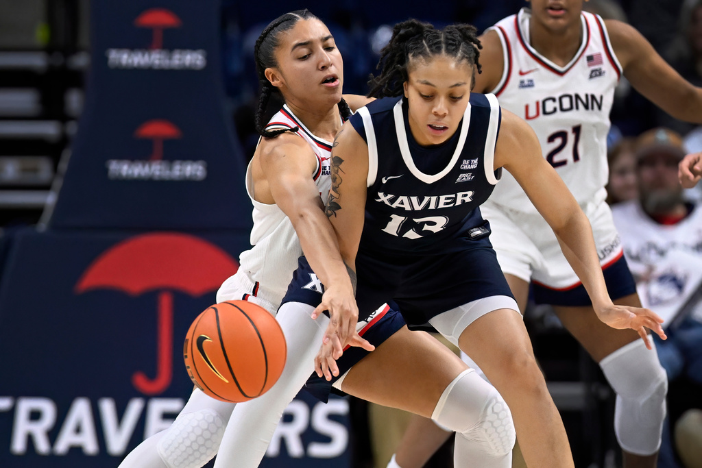 UConn guard Azzi Fudd, left, knocks the ball from Xavier guard Mariyah Noel, right, in the first half of an NCAA college basketball game, Wednesday, Jan. 28, 2026, in Storrs, Conn. (AP Photo/Jessica Hill)