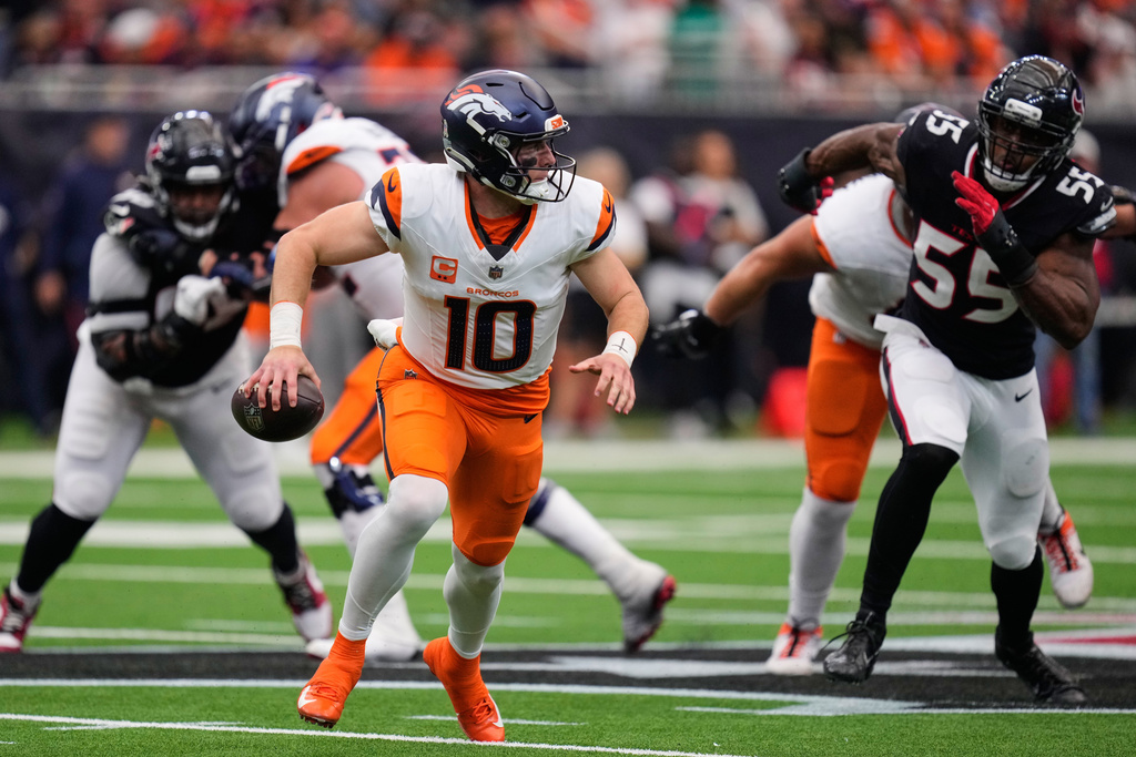 Denver Broncos quarterback Bo Nix (10) scrambles out of the pocket under pressure from Houston Texans defensive end Danielle Hunter (55) in the second half of an NFL football game Sunday, Nov. 2, 2025, in Houston. (AP Photo/Eric Christian Smith)