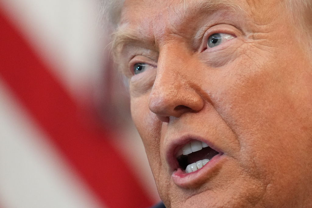 President Donald Trump speaks to reporters before signing an executive order in the Oval Office at the White House, Monday, Oct. 6, 2025, in Washington. (AP Photo/Jacquelyn Martin)