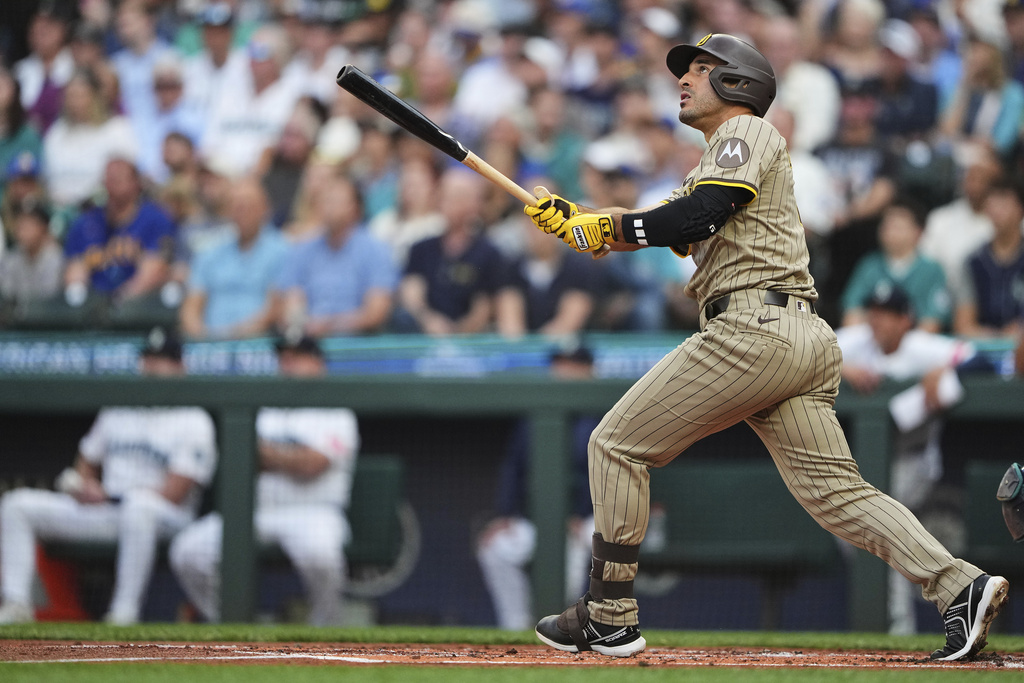 San Diego Padres' Ramon Laureano follows through on a grand slam against the Seattle Mariners during the first inning of a baseball game Tuesday, Aug. 26, 2025, in Seattle. (AP Photo/Lindsey Wasson)