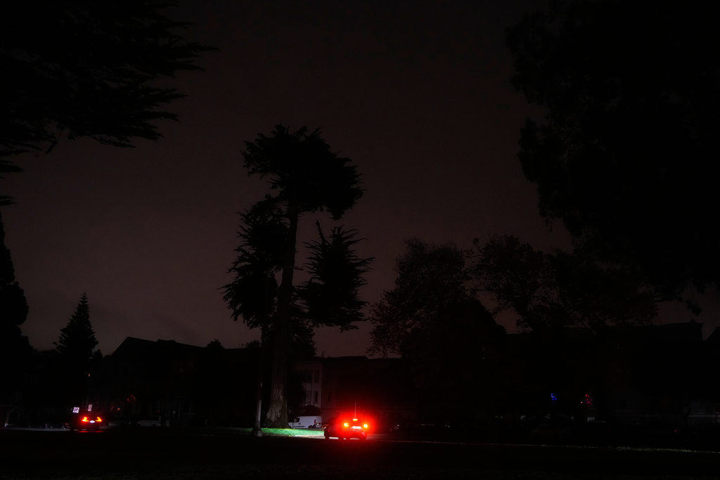 The taillights from a vehicle are shown as power outages darken the streets, in San Francisco, Saturday, Dec. 20, 2025. (AP Photo/Jeff Chiu)