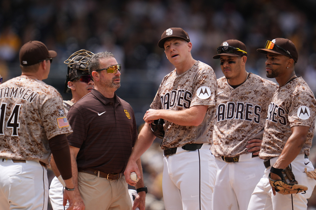 San Diego Padres pitcher Nick Pivetta, center, reacts before exiting during the fourth inning of a baseball game against the Colorado Rockies Sunday, April 12, 2026, in San Diego. (AP Photo/Gregory Bull)