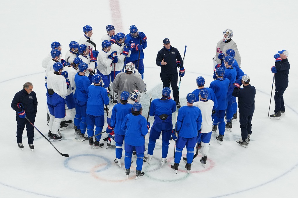 United States' head coach Mike Sullivan, center, speaks to his team during men's ice hockey practice at the 2026 Winter Olympics, in Milan, Italy, Sunday, Feb. 8, 2026. (AP Photo/Carolyn Kaster)