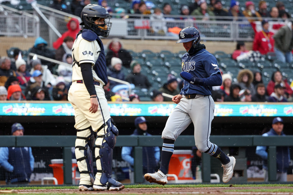 Tampa Bay Rays' Ben Williamson, right, scores on a double hit by Jonathan Aranda during the second inning of baseball game against the Minnesota Twins, Saturday, April 4, 2026, in Minneapolis. (AP Photo/Matt Krohn)