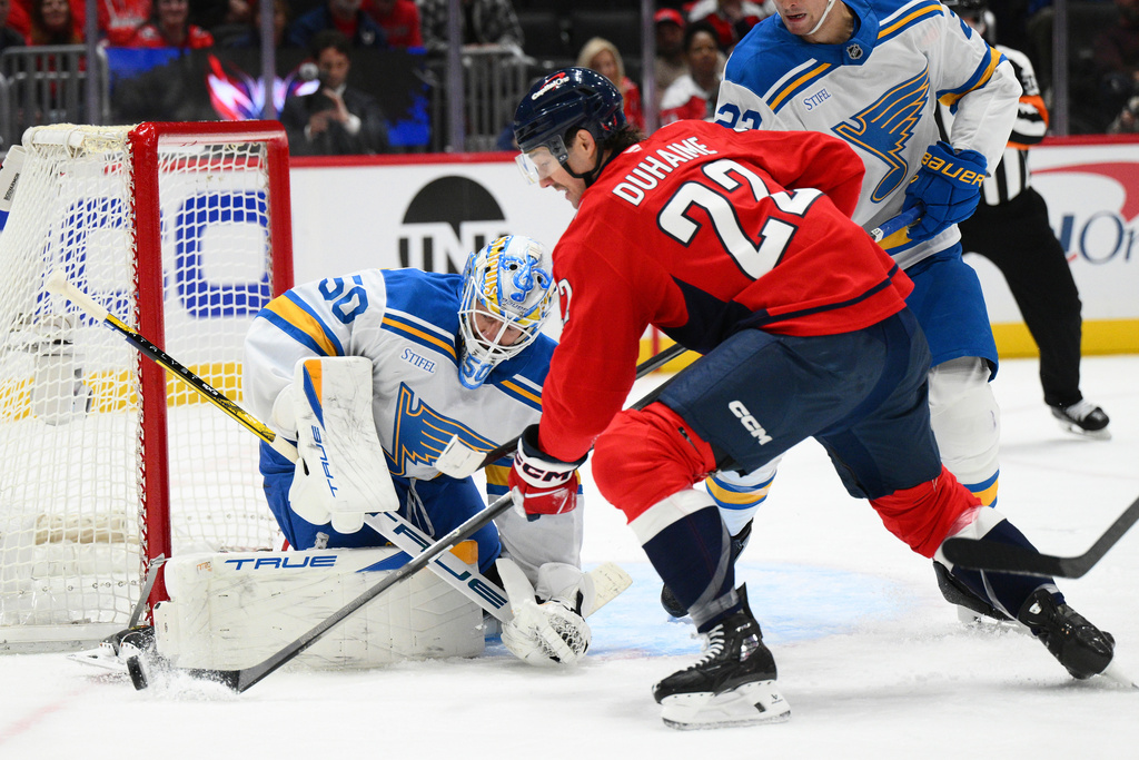 Washington Capitals right wing Brandon Duhaime (22) has his shot block by St. Louis Blues goaltender Jordan Binnington (50) during the first period of an NHL hockey game, Wednesday, Nov. 5, 2025, in Washington. (AP Photo/Nick Wass)