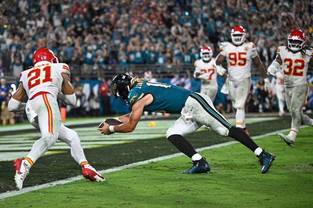 Jacksonville Jaguars quarterback Trevor Lawrence (16) dives into the end zone to score a touchdown during the second half of an NFL football game against the Kansas City Chiefs, Monday, Oct. 6, 2025, in Jacksonville, Fla. (AP Photo/Phelan M. Ebenhack)